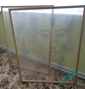 Frames covered in gauze showing the faces of Akhenaten and Nefertiti, drawn using quick diagonal cross-hatching with inktense blocks. They are set at an angle so that you look through them.