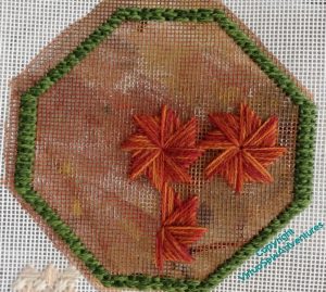Picture of an octagonal border with two and a half large Milanese pinwheels in place. Somehow they look awkward.