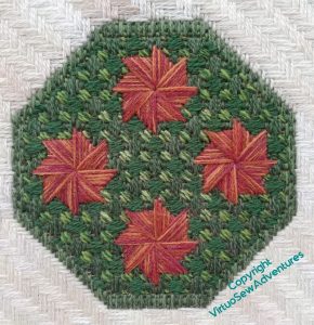 A single octagonal border, with four reddish pinwheels in a diamond shape, and Palace Stitch surrounding them. There is a lighter green in the centre, within the pinwheels.