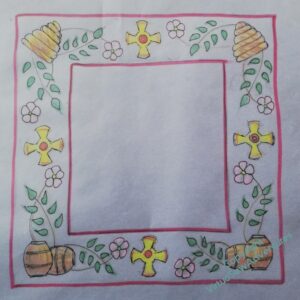 A coloured tracing of the design on tracing paper laid over blue card.