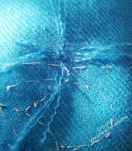 Darning the holes in the Lotus Flower Coat - lots of ends of thread taken from cut off pieces of the fabric, woven not as neatly as I would have liked into the main piece, and at present not trimmed.