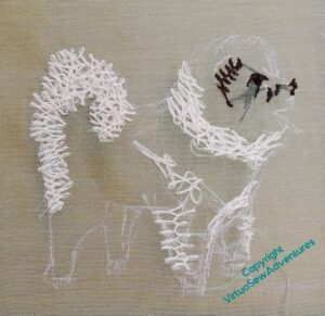 A lot of cream stitching in place and the start of the dark for the eye and ear.